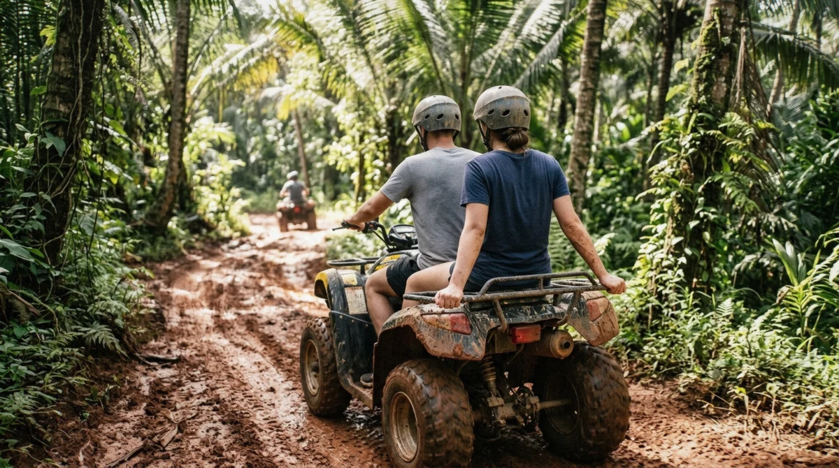 Two riders sharing one tandem quad bike on an Ubud ATV tour track, one driving and one holding on